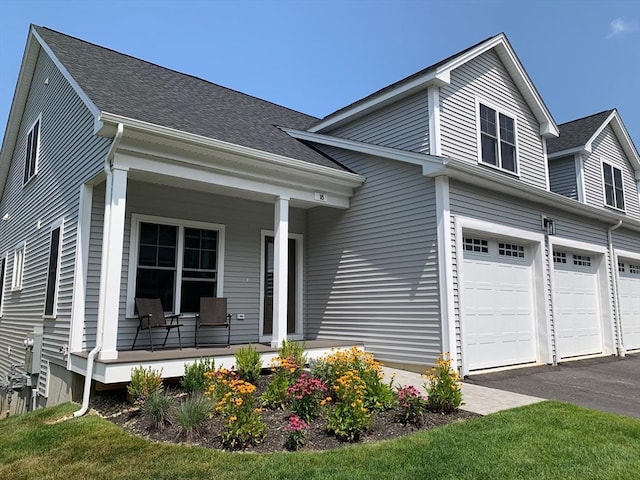 view of front of property with a porch and a garage