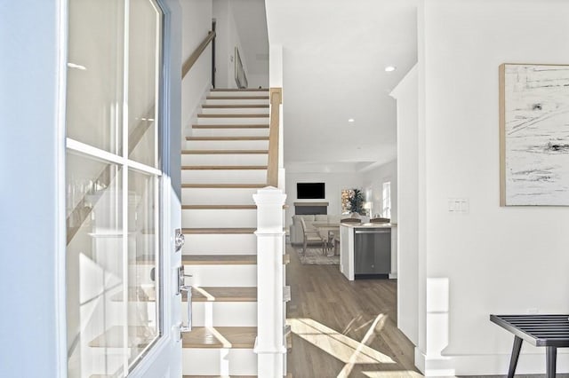 stairway with hardwood / wood-style flooring