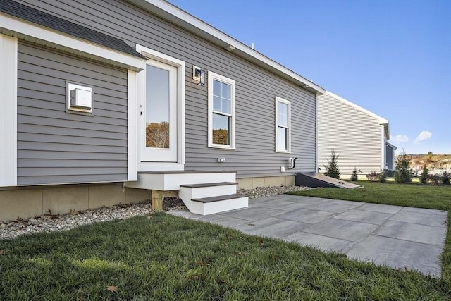 doorway to property featuring a yard