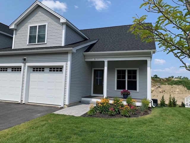 view of front of house with a front yard and a garage