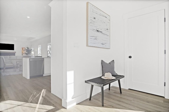 corridor with light hardwood / wood-style floors