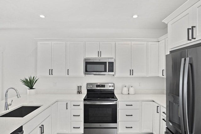 kitchen with sink, white cabinetry, and stainless steel appliances