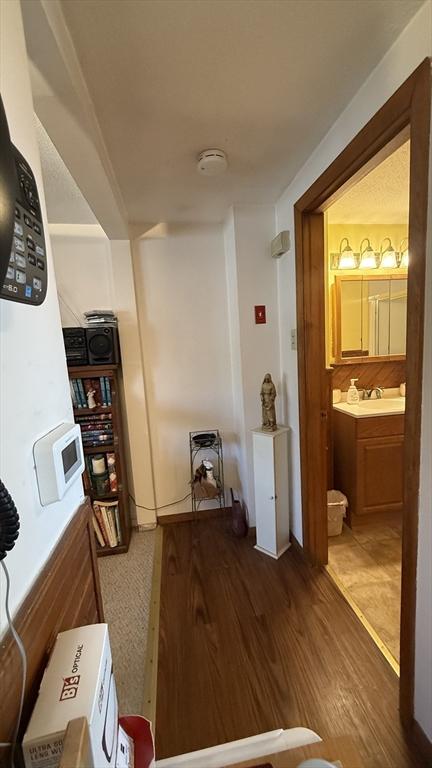 13 Ridgewood Cir, Lawrence, NY 10843 - corridor with wood finished floors and a sink