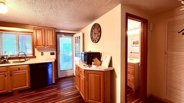13 Ridgewood Cir, Lawrence, NY 10843 - kitchen with black appliances, dark wood finished floors, a textured ceiling, light countertops, and a sink