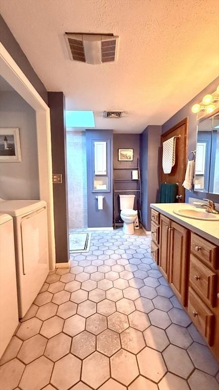 13 Ridgewood Cir, Lawrence, NY 10843 - bathroom with washer and dryer, vanity, tile patterned flooring, and healthy amount of natural light