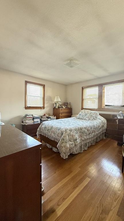 13 Ridgewood Cir, Lawrence, NY 10843 - bedroom featuring wood finished floors and a textured ceiling