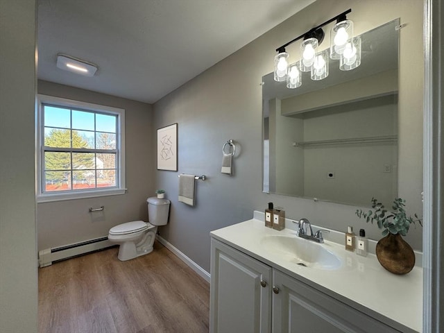 bathroom featuring hardwood / wood-style floors, vanity, toilet, and a baseboard heating unit