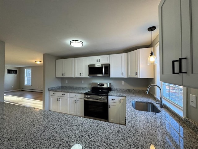 kitchen featuring stainless steel appliances, white cabinetry, and sink