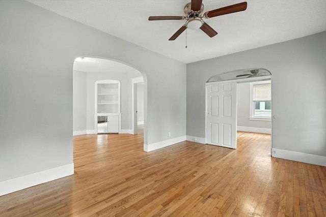 31-33 Dorset St, Springfield, MA 01108 - unfurnished room featuring a ceiling fan, arched walkways, and light wood-style floors