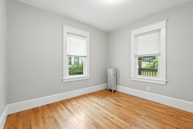31-33 Dorset St, Springfield, MA 01108 - empty room with radiator, healthy amount of natural light, and wood finished floors