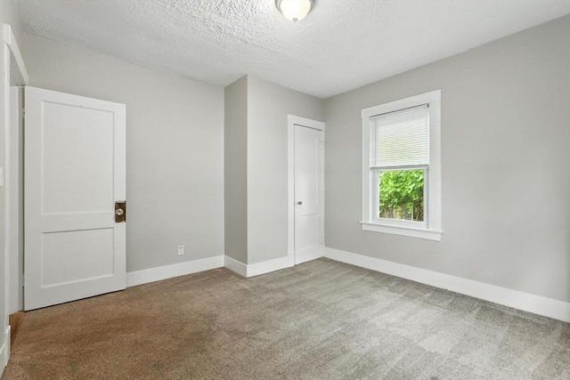 31-33 Dorset St, Springfield, MA 01108 - carpeted empty room with baseboards and a textured ceiling