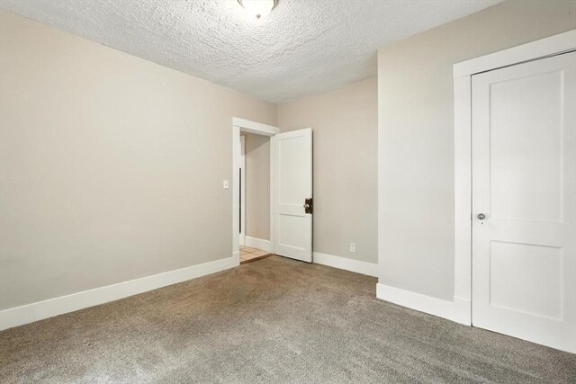 31-33 Dorset St, Springfield, MA 01108 - unfurnished bedroom featuring carpet, a textured ceiling, and a closet