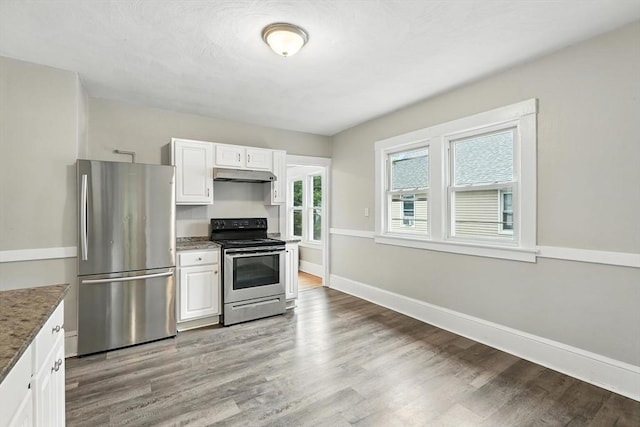 31-33 Dorset St, Springfield, MA 01108 - kitchen featuring stainless steel appliances, under cabinet range hood, wood finished floors, white cabinetry, and stone countertops
