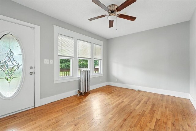 31-33 Dorset St, Springfield, MA 01108 - entrance foyer with radiator heating unit, light wood-type flooring, and ceiling fan