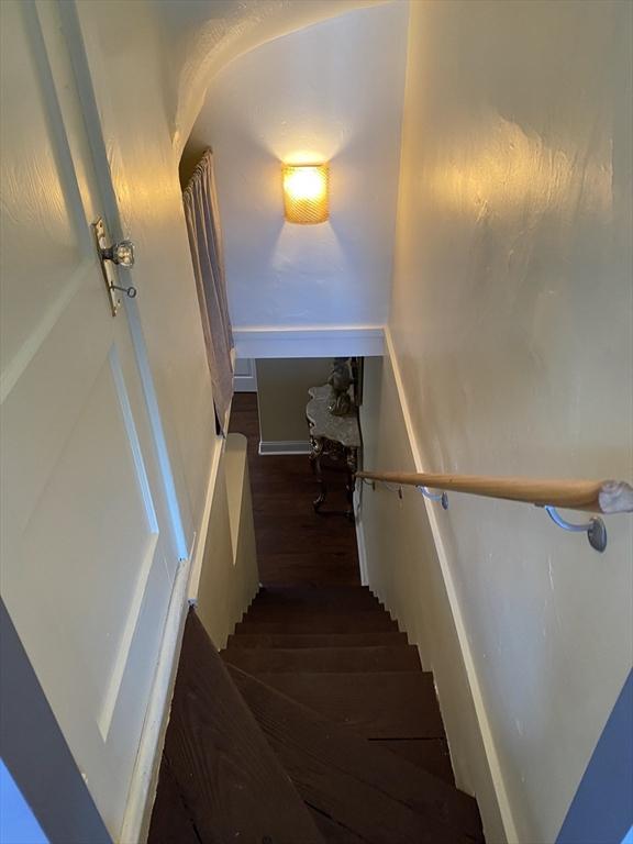 staircase with hardwood / wood-style floors