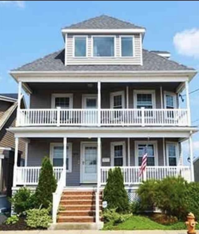 view of front of house featuring a balcony and covered porch