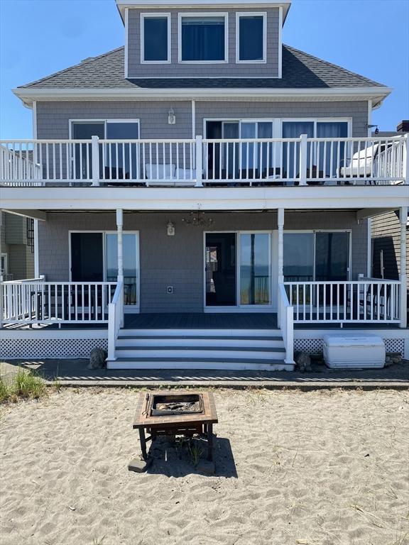 rear view of property with a fire pit