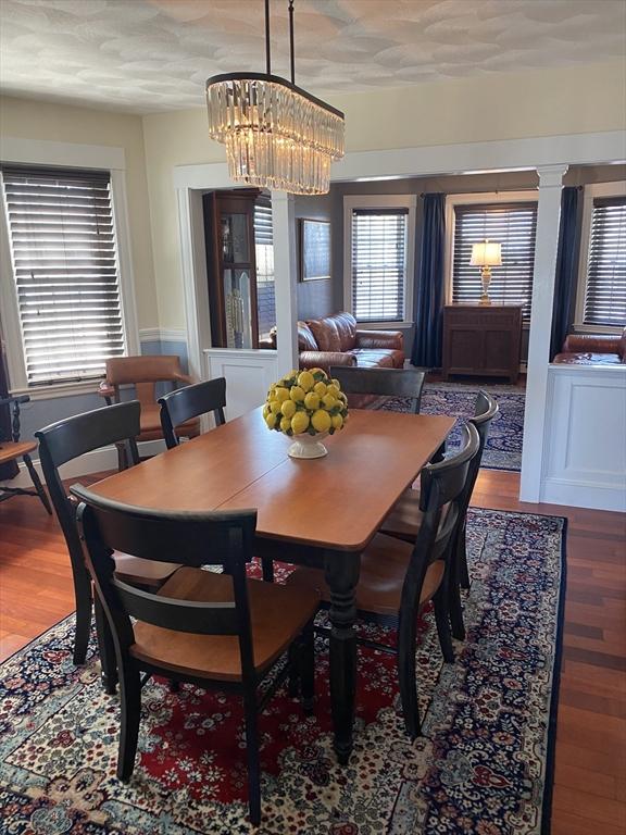 dining area featuring hardwood / wood-style flooring and a chandelier