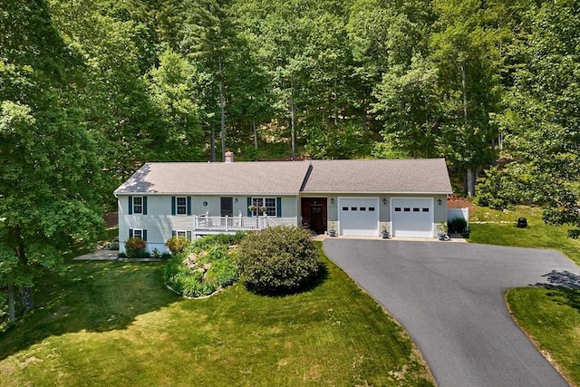 43 Ridge Rd, Erving, MA 01344 - single story home featuring an attached garage, asphalt driveway, a front lawn, stone siding, and a shingled roof