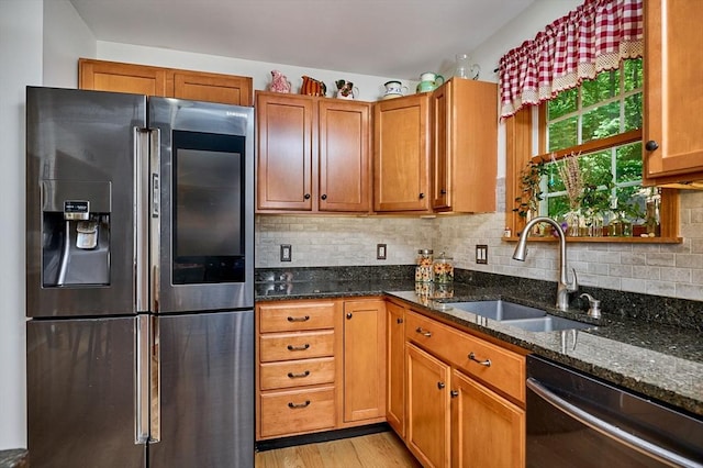 43 Ridge Rd, Erving, MA 01344 - kitchen featuring stainless steel refrigerator with ice dispenser, dishwasher, a sink, dark stone countertops, and light wood-type flooring