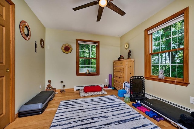 43 Ridge Rd, Erving, MA 01344 - rec room featuring a baseboard heating unit, a ceiling fan, and wood finished floors