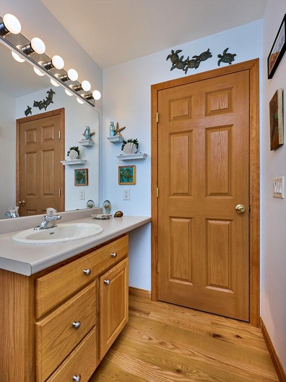 43 Ridge Rd, Erving, MA 01344 - bathroom with vanity, wood finished floors, and baseboards