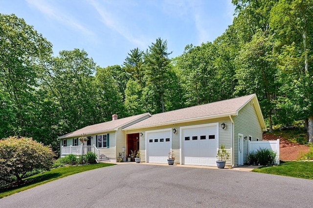 43 Ridge Rd, Erving, MA 01344 - ranch-style home with a garage, a chimney, and a porch