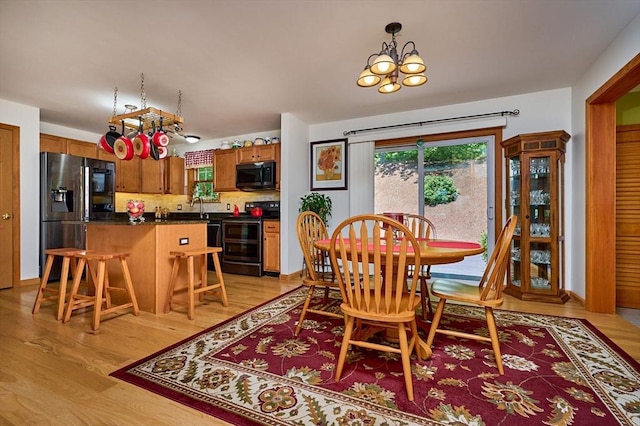 43 Ridge Rd, Erving, MA 01344 - dining room with light wood finished floors and a chandelier