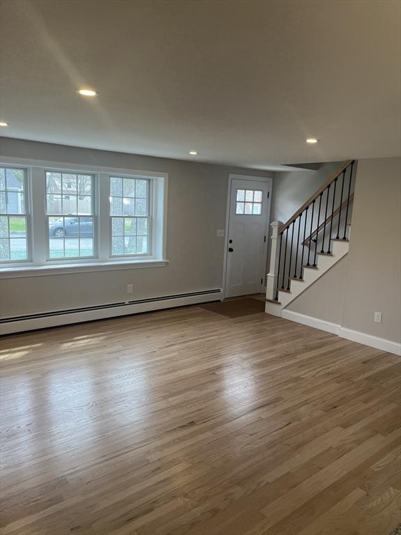 23 Town Hall Ave, Yarmouth, MA 02664 - foyer entrance with baseboard heating, stairway, wood finished floors, baseboards, and recessed lighting