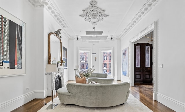 sitting room featuring an inviting chandelier, crown molding, and wood-type flooring