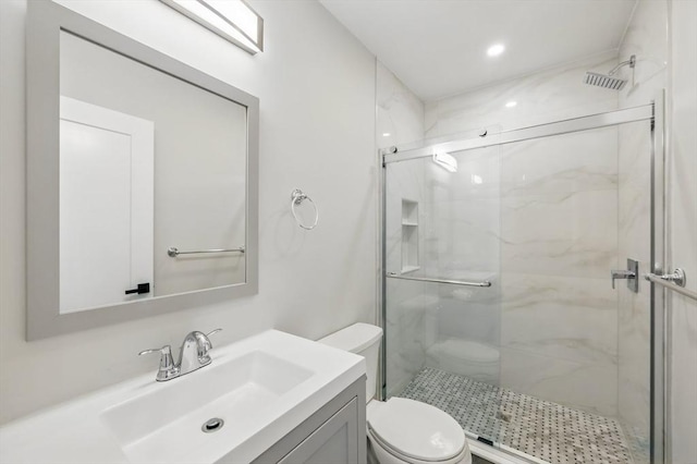 full bath with a marble finish shower, vanity, and toilet