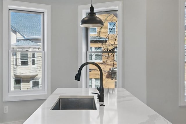 details featuring a sink and pendant lighting