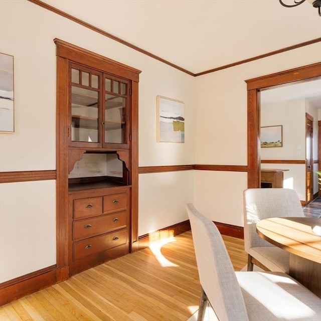 office featuring light wood-type flooring and ornamental molding