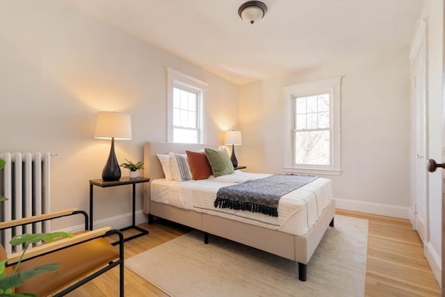 bedroom featuring light hardwood / wood-style floors and radiator heating unit