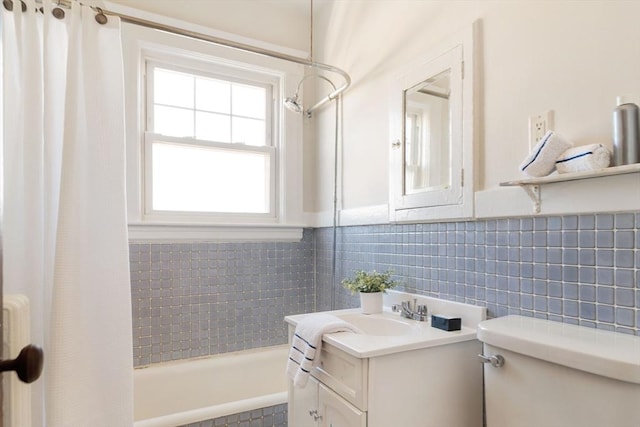 full bathroom featuring toilet, vanity, and shower / bath combination with curtain