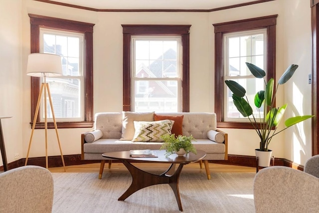 sitting room featuring a wealth of natural light, crown molding, and light hardwood / wood-style flooring