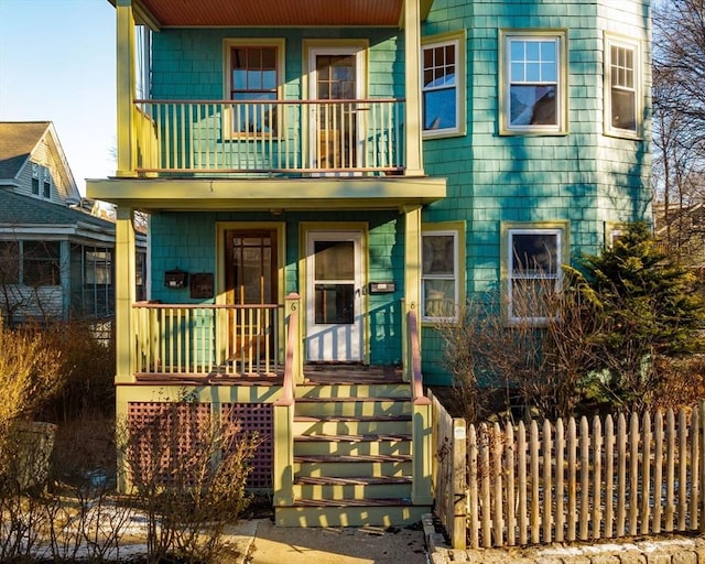 view of front of house with a balcony and covered porch