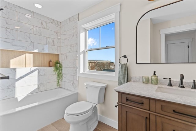 bathroom with hardwood / wood-style floors, vanity, toilet, and a tub