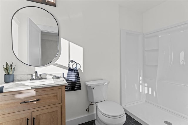 bathroom with a shower, tile patterned floors, vanity, and toilet