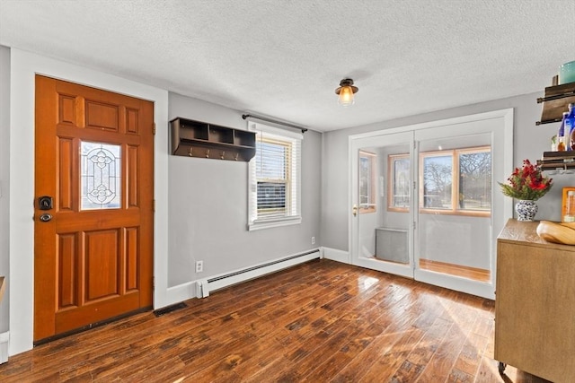 foyer featuring a textured ceiling, dark hardwood / wood-style floors, and baseboard heating