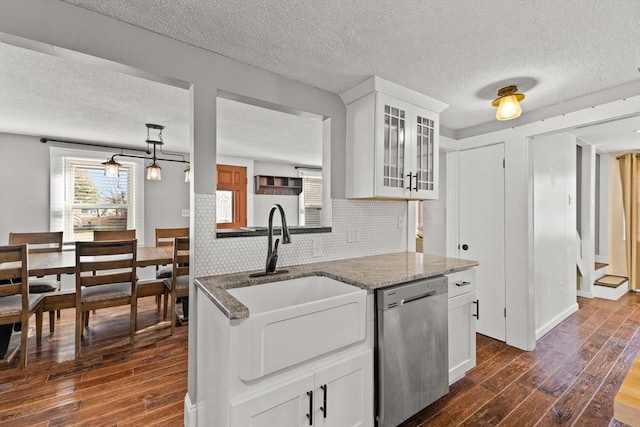 kitchen with dishwasher, white cabinets, tasteful backsplash, and sink