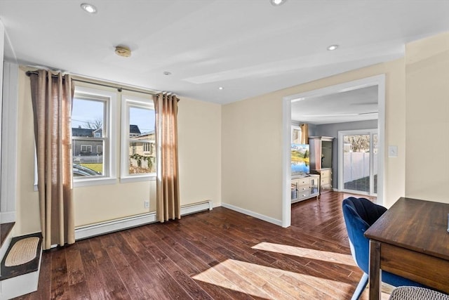 interior space with a baseboard radiator, plenty of natural light, and dark wood-type flooring