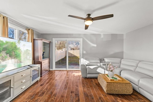 living room featuring ceiling fan and dark hardwood / wood-style flooring