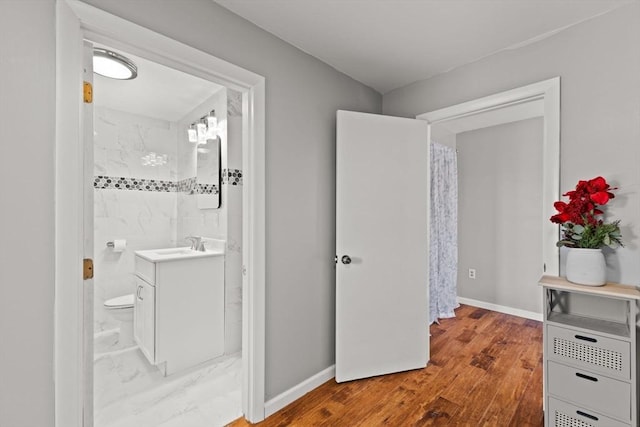 bathroom featuring hardwood / wood-style floors, vanity, and toilet