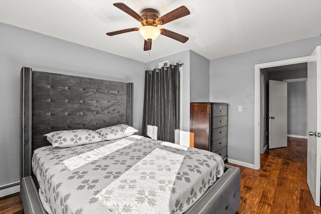 bedroom with a baseboard radiator, ceiling fan, and dark wood-type flooring