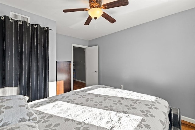 bedroom featuring ceiling fan and hardwood / wood-style flooring