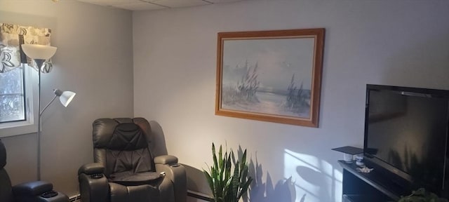 sitting room with a paneled ceiling