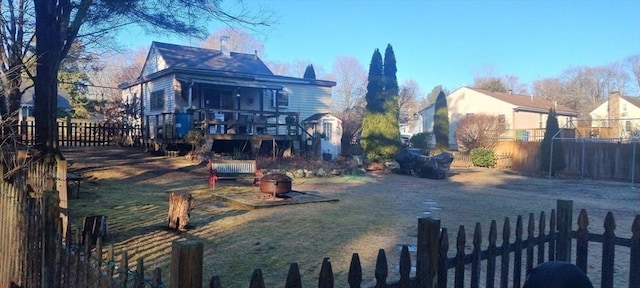 view of yard featuring a deck and an outdoor fire pit