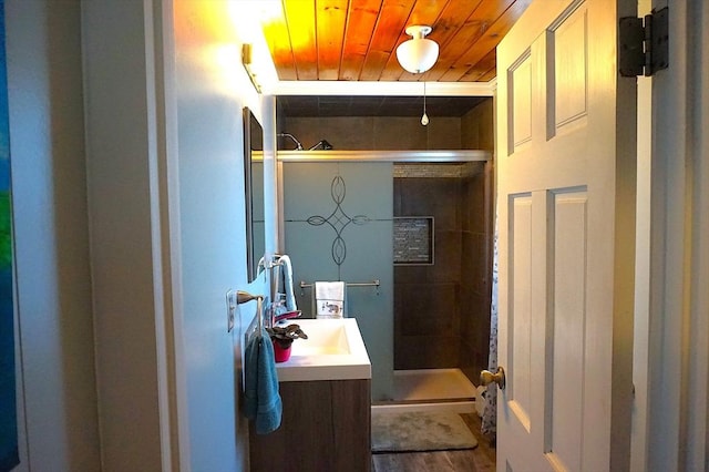 bathroom with vanity, an enclosed shower, and wood ceiling