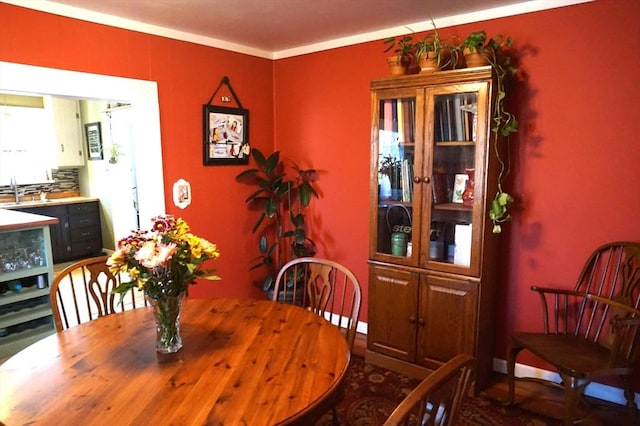 dining area featuring crown molding